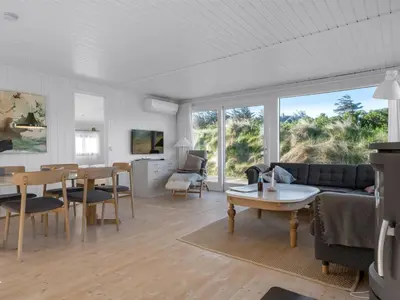 a living room with a couch and a table at Holiday Home Asser - 400m from the sea by Interhome in Saltum