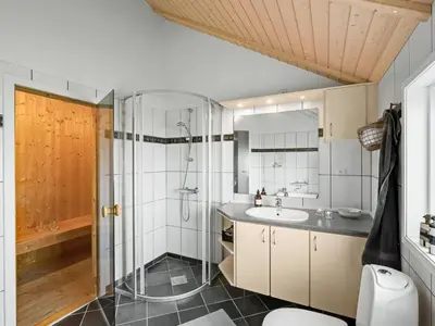 a bathroom with a shower and a sink at Holiday Home Sochyeta - 150m from the sea by Interhome in Harboør