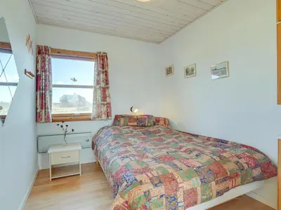 a bedroom with a bed and a window at Holiday Home Soyala - 400m from the sea by Interhome in Harboør