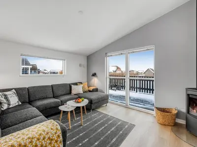 a living room with a couch and a fireplace at Holiday Home Damaskin - 300m from the sea by Interhome in Harboør