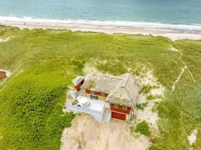 an aerial view of a house on the beach at Holiday Home Zora - 100m from the sea by Interhome in Harboør