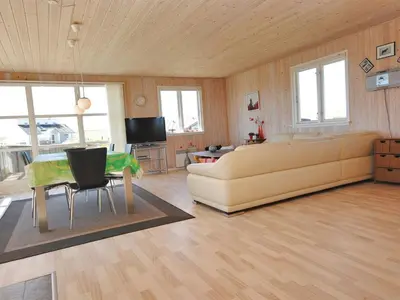 a living room with a couch and a table at Holiday Home Ernbiorn - from the sea by Interhome in Harboør