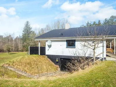a white house with a black roof at 7 person holiday home in Skals-By Traum in Skals