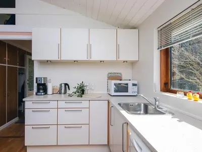 a kitchen with white cabinets and a sink and a window at 7 person holiday home in Skals-By Traum in Skals