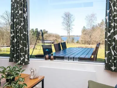 a table in a window with a view of the water at 7 person holiday home in Skals-By Traum in Skals