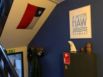 a room with a blue wall with a flag at La Ola in Hanstholm