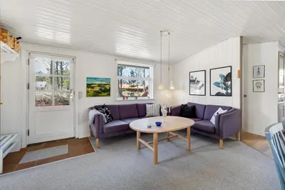 a living room with purple couches and a table at Cozy Holiday Home in Lovely Surroundings in Sønder Vorupør