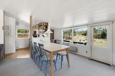 a kitchen and dining room with a table and chairs at Cozy Holiday Home in Lovely Surroundings in Sønder Vorupør