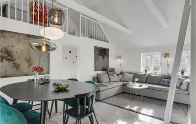 a living room with a table and a couch at Amazing Home In Pandrup in Pandrup