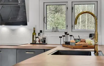 a kitchen with a sink and a counter with a tray of food at Amazing Home In Pandrup in Pandrup