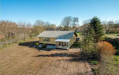 an aerial view of a small house in a field at 3 Bedroom Awesome Home In Thisted in Thisted