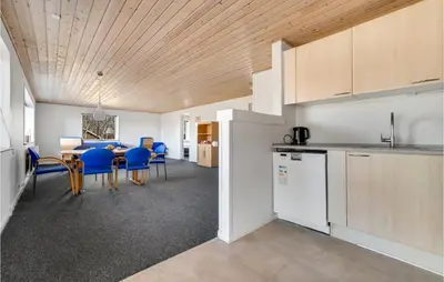 a kitchen and dining room with a table and chairs at 3 Bedroom Awesome Home In Thisted in Thisted