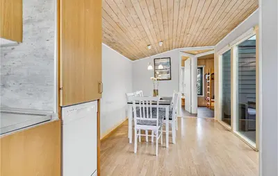 a kitchen and dining room with a table and chairs at 2 Bedroom Stunning Home In Hanstholm in Hanstholm