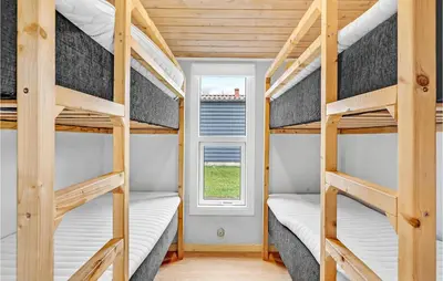 two bunk beds in a tiny house with a window at 2 Bedroom Stunning Home In Hanstholm in Hanstholm