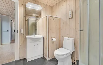 a bathroom with a toilet and a sink at 2 Bedroom Stunning Home In Hanstholm in Hanstholm