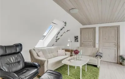 a living room with two couches and a table at 3 Bedroom Cozy Home In Vesløs in Vesløs