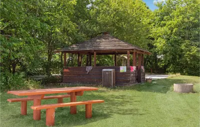a picnic table and a gazebo in a park at Cozy Home In Nykøbing M With Wifi in Refshammer