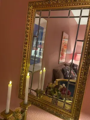 an ornate gold mirror with candles in front of a couch at Skuespiller Centralen in Viborg