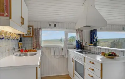 a kitchen with white counters and a sink and two windows at 3 Bedroom Lovely Home In Lemvig in Lemvig
