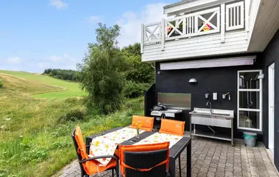 a house with a table and chairs and a sink at Nice Home In Fur With Sauna in Furland