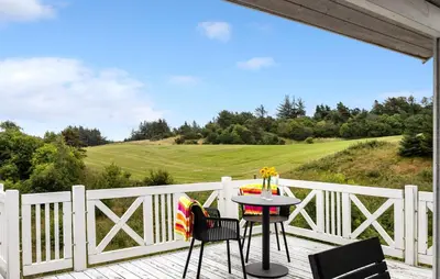a patio with a table and chairs on a white fence at Nice Home In Fur With Sauna in Furland