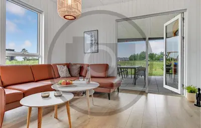 a living room with a couch and a table at 4 Bedroom Beautiful Home In Løgstrup in Løgstrup