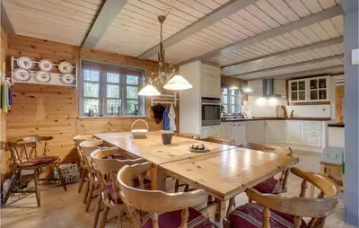 a kitchen with a large wooden table and chairs at 3 Bedroom Gorgeous Home In Højslev in Højslev