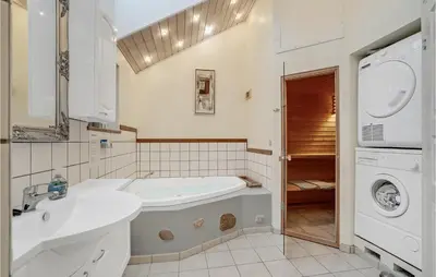 a bathroom with a sink and a washing machine at 3 Bedroom Gorgeous Home In Højslev in Højslev