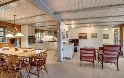 a kitchen and dining room with a table and chairs at 3 Bedroom Gorgeous Home In Højslev in Højslev