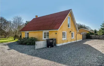 a yellow house with a red roof at Lovely Home In Pandrup With Wifi in Pandrup