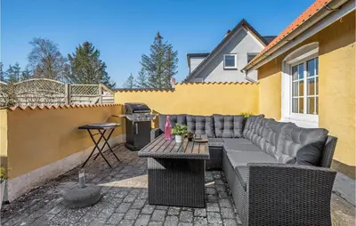 a patio with a couch and a table and a grill at Lovely Home In Pandrup With Wifi in Pandrup