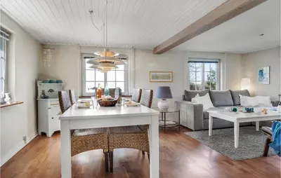 a living room with a table and a couch at Lovely Home In Pandrup With Wifi in Pandrup