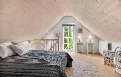 a bedroom with a large bed in a attic at Lovely Home In Pandrup With Wifi in Pandrup