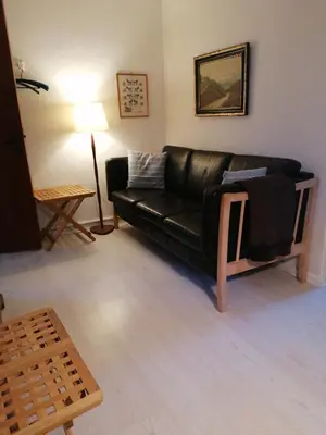 a black leather couch in a living room at B&B Tvolm Ydby Thy in Tvolm