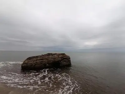 a large rock in the water on the beach at 4 person holiday home in Frøstrup in Frøstrup