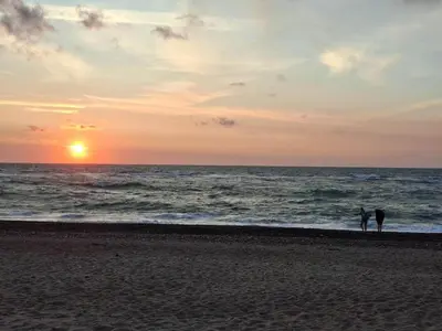 two people standing on the beach watching the sunset at 4 person holiday home in Frøstrup in Frøstrup