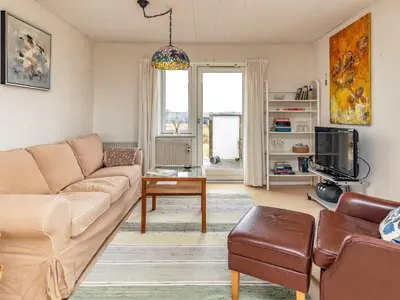 a living room with a couch and a tv at 4 person holiday home in Frøstrup in Frøstrup