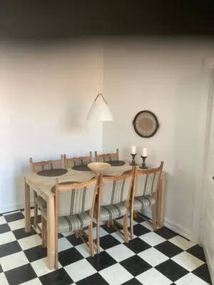 a dining room with a table and chairs at Store Sand in Vemb