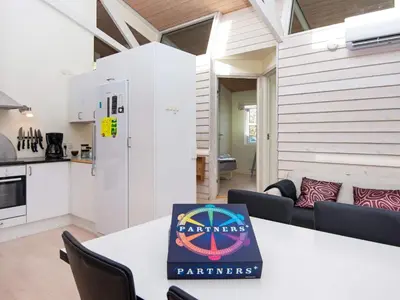 a kitchen and living room with a table with a book on it at 6 person holiday home in Vemb-By Traum in Vemb