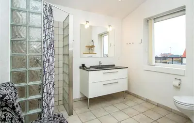 a bathroom with a sink and a toilet at Lovely Home In Thisted With Kitchen in Thisted