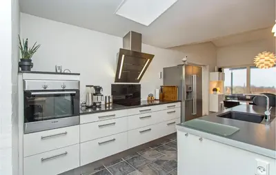 a kitchen with white cabinets and stainless steel appliances at Lovely Home In Thisted With Kitchen in Thisted
