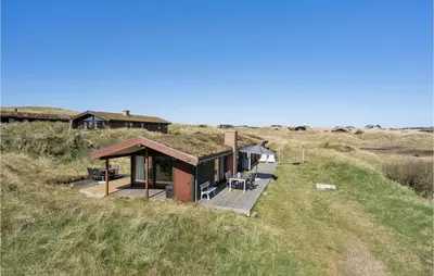 a house with a grass roof on top of a hill at Beautiful Home In Løkken With Wifi in Løkken