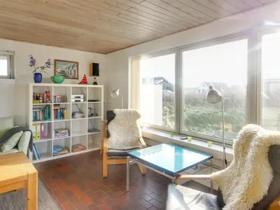 a living room with a glass coffee table and a window at Holiday Home Ågot - 75m from the sea by Interhome in Torsted