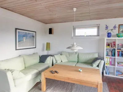 a living room with a couch and a coffee table at Holiday Home Ågot - 75m from the sea by Interhome in Torsted