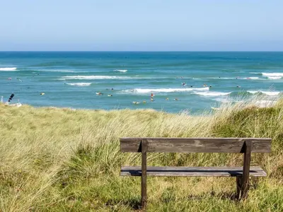 a wooden bench sitting on top of a beach at Holiday Home Arngrim - 100m from the sea by Interhome in Torsted