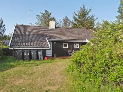 a black house with a yard in front of it at Holiday Home Gottliebe - 850m from the sea by Interhome in Torsted