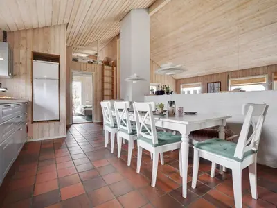 a kitchen with a white table and chairs at Holiday Home Gottliebe - 850m from the sea by Interhome in Torsted