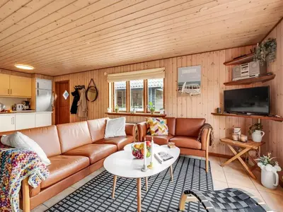 a living room with a couch and a table at Holiday Home Engeline - 300m to the fjord by Interhome in Vemb