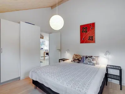 a bedroom with a bed in a white room at Holiday Home Daina - 400m to the fjord by Interhome in Vemb