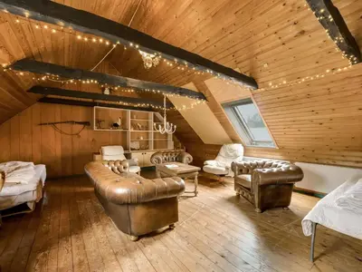 a living room with leather furniture and a wooden ceiling at Holiday Home Wilmar - 1km to the fjord by Interhome in Vemb